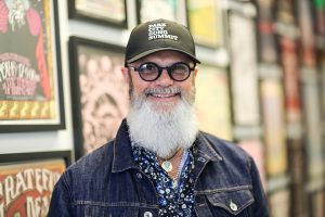 Ben Anderson against a backdrop of colorful framed posters