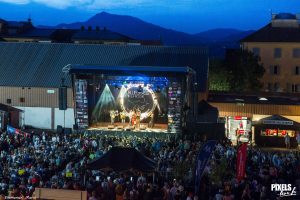 Mountains behind a festival stage at dusk